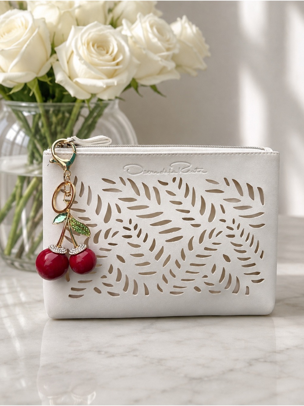Oscar de la Renta White Laser-Cut Leather Wristlet with Cherry Charm